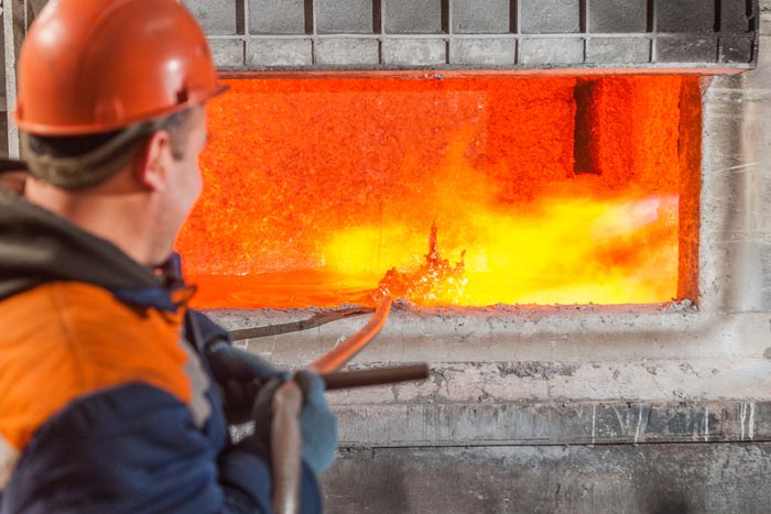 Smelter near melting furnace with molten aluminum, foundry, Russia