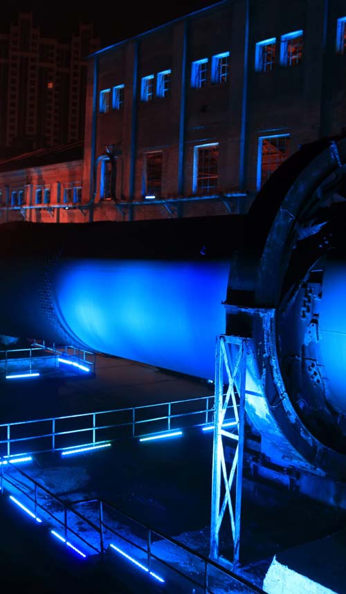 idle cement plant rotary kiln machinery at night